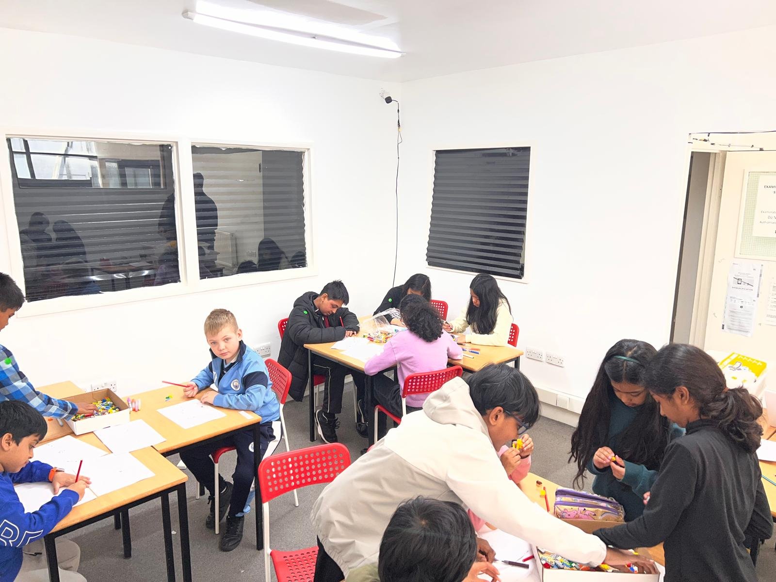 Children working in small groups during a holiday camp session
