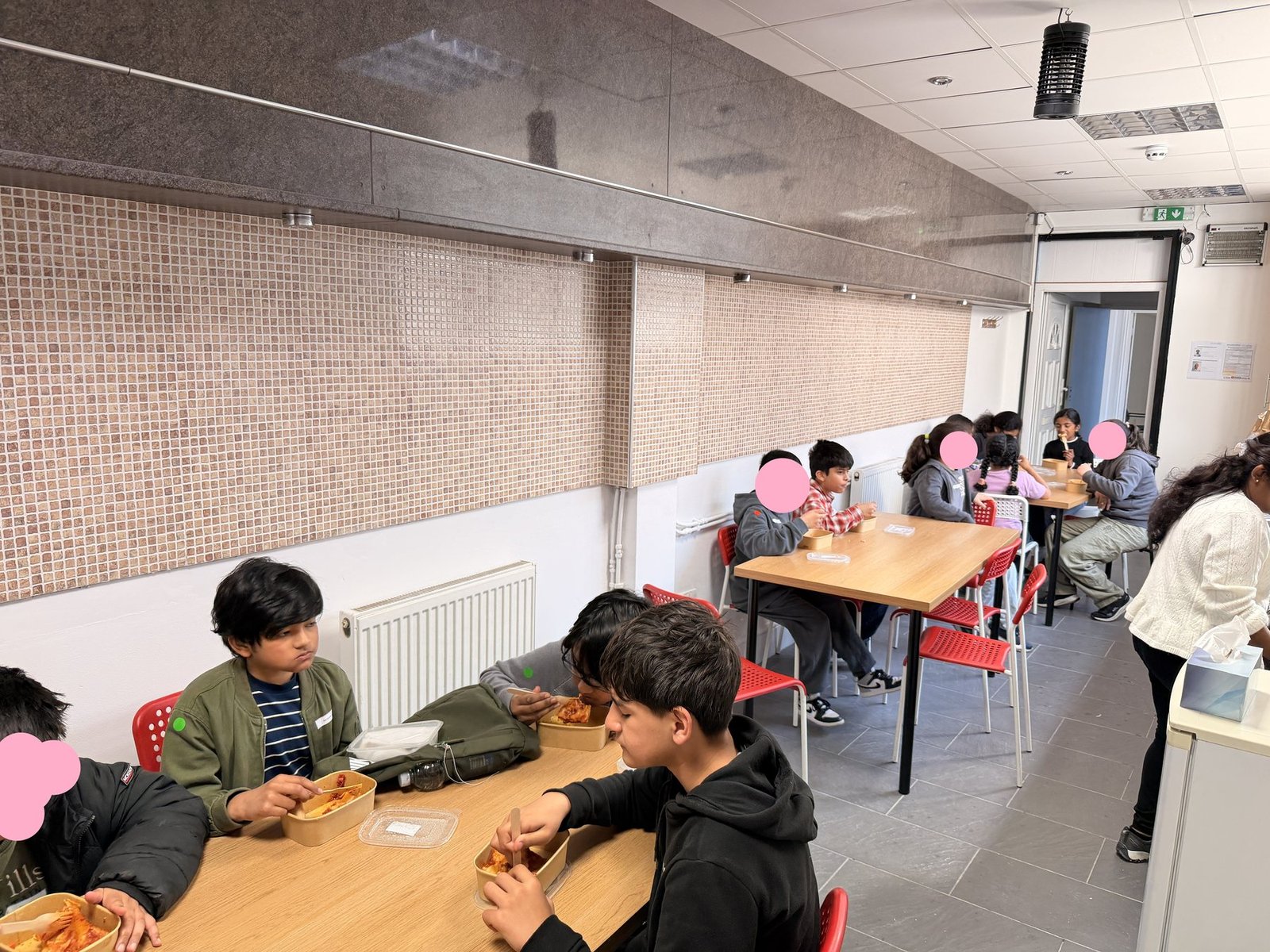 Children having lunch during the holiday camp programme