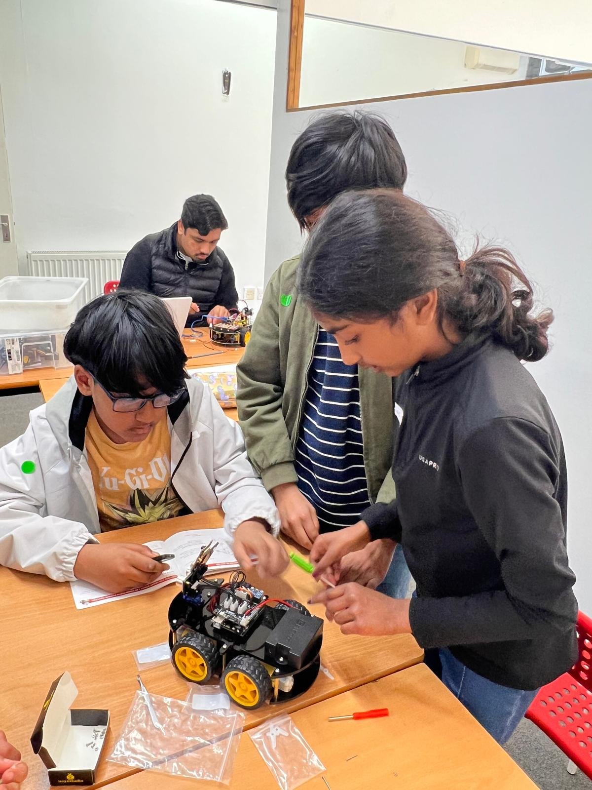 Students working together to build a robot during a STEM Explorers session